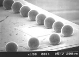 Pt/PbSn process steps (SEM images); a) Platinum stud bumping on silicon test chips with Aluminum pads, b) coining of Platinum stud bumps to create a smooth surface, c) after SnPb stud bumping and reflow