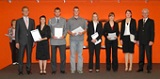 Janine Scholtz (2nd from the right) receives her certificate from IHK-president Dr. Eric Schweitzer (far right)